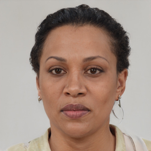 Joyful latino adult female with short  brown hair and brown eyes