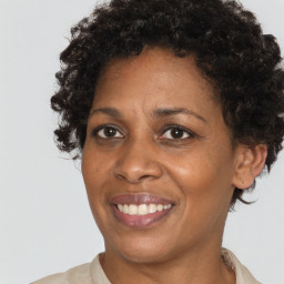 Joyful black adult female with short  brown hair and brown eyes