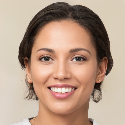 Joyful white young-adult female with medium  brown hair and brown eyes