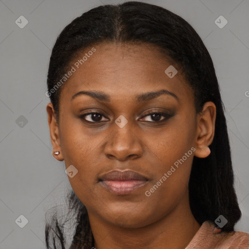 Joyful black young-adult female with long  black hair and brown eyes