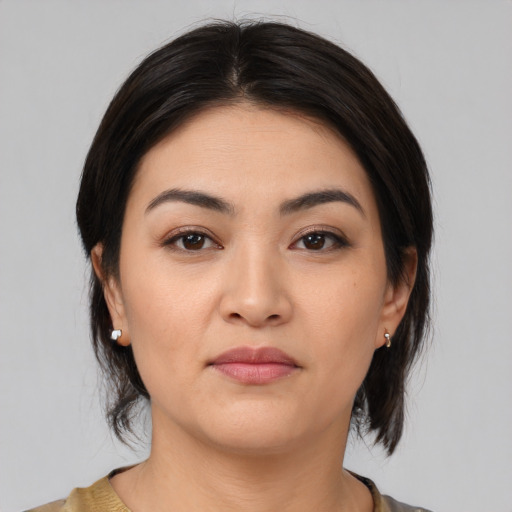 Joyful white young-adult female with medium  black hair and brown eyes
