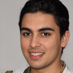 Joyful white young-adult male with short  black hair and brown eyes