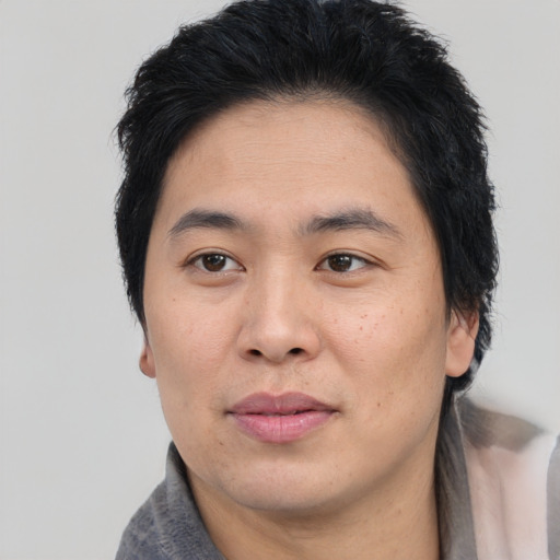 Joyful asian young-adult male with medium  brown hair and brown eyes
