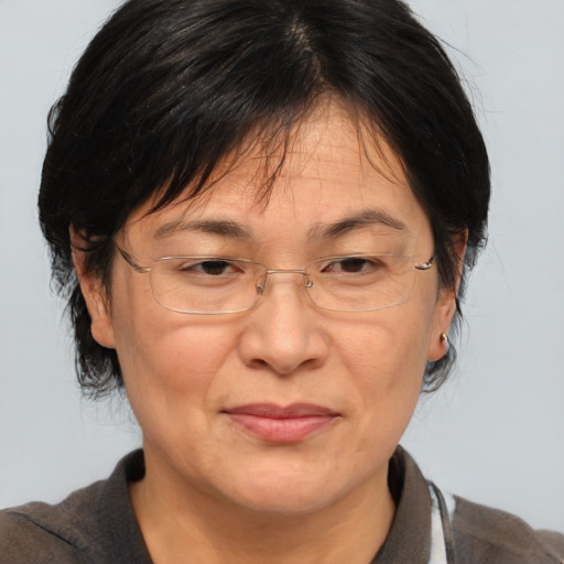 Joyful white middle-aged female with medium  brown hair and brown eyes