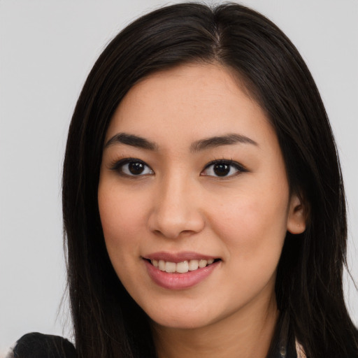 Joyful latino young-adult female with long  black hair and brown eyes