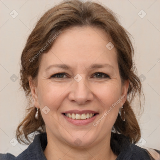 Joyful white adult female with medium  brown hair and grey eyes