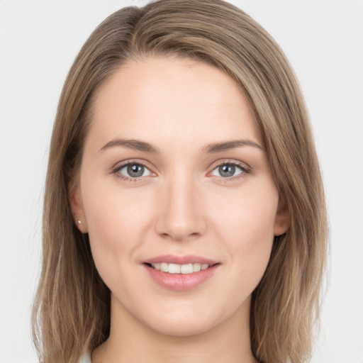 Joyful white young-adult female with long  brown hair and grey eyes