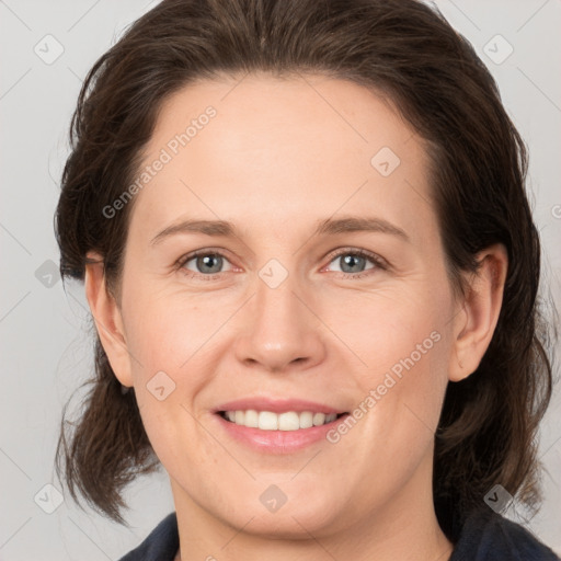 Joyful white adult female with medium  brown hair and grey eyes