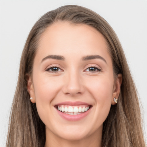 Joyful white young-adult female with long  brown hair and grey eyes