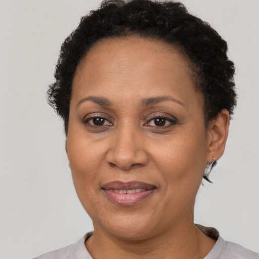 Joyful latino adult female with short  brown hair and brown eyes