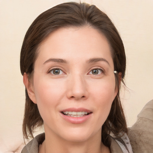 Joyful white young-adult female with medium  brown hair and brown eyes