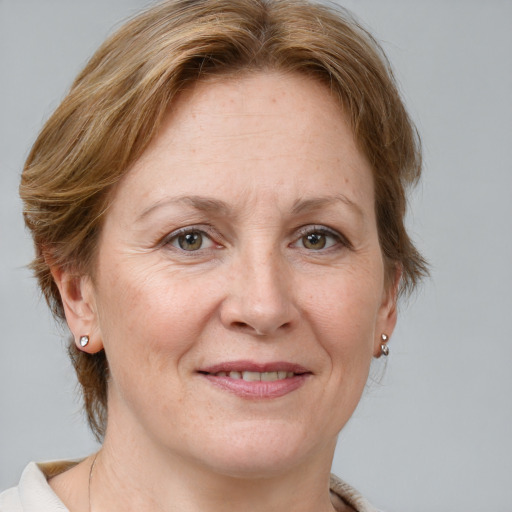 Joyful white adult female with medium  brown hair and grey eyes