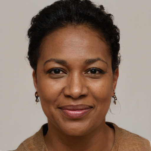 Joyful black adult female with short  brown hair and brown eyes