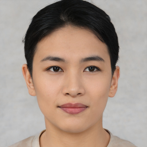 Joyful asian young-adult female with short  black hair and brown eyes