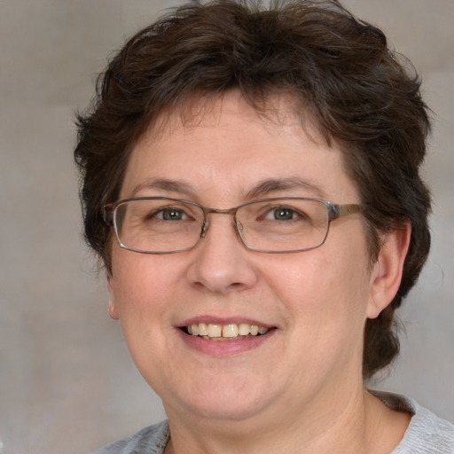 Joyful white adult female with medium  brown hair and blue eyes