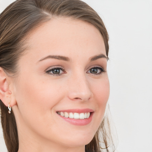 Joyful white young-adult female with long  brown hair and blue eyes