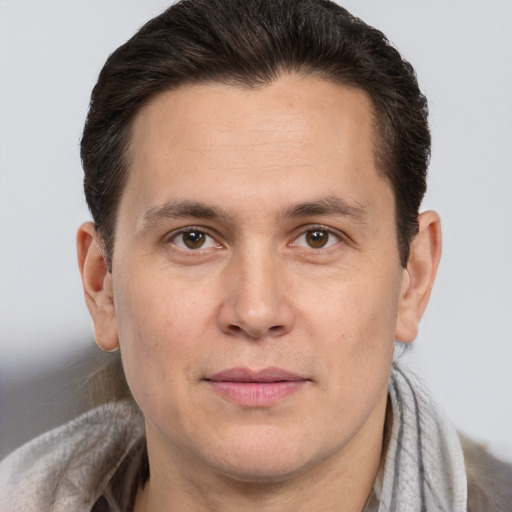 Joyful white adult male with short  brown hair and brown eyes