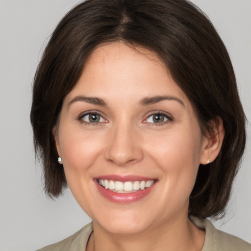 Joyful white young-adult female with medium  brown hair and brown eyes