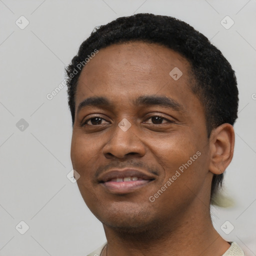 Joyful black young-adult male with short  black hair and brown eyes