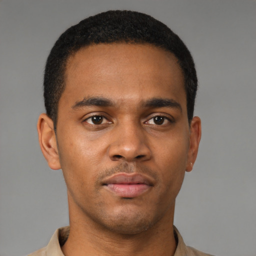 Joyful latino young-adult male with short  brown hair and brown eyes