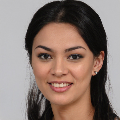 Joyful asian young-adult female with long  brown hair and brown eyes