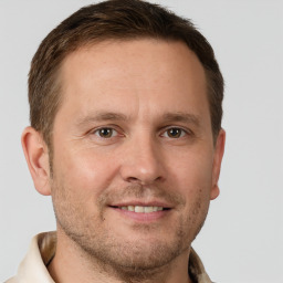 Joyful white adult male with short  brown hair and brown eyes