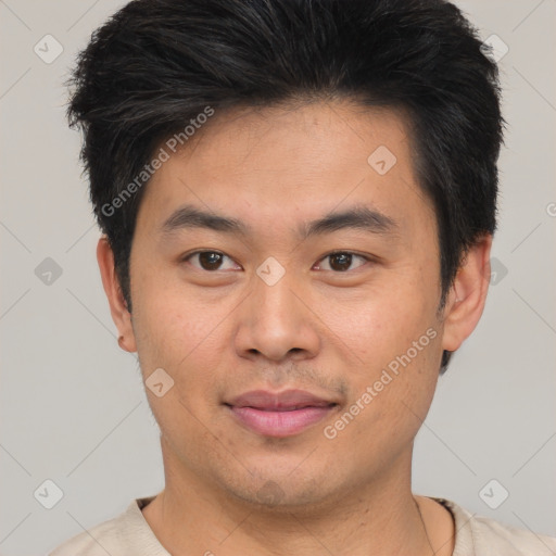 Joyful asian young-adult male with short  brown hair and brown eyes