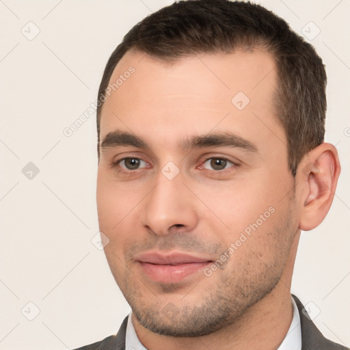 Joyful white young-adult male with short  brown hair and brown eyes