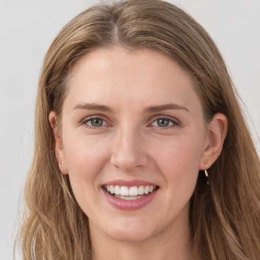 Joyful white young-adult female with long  brown hair and grey eyes