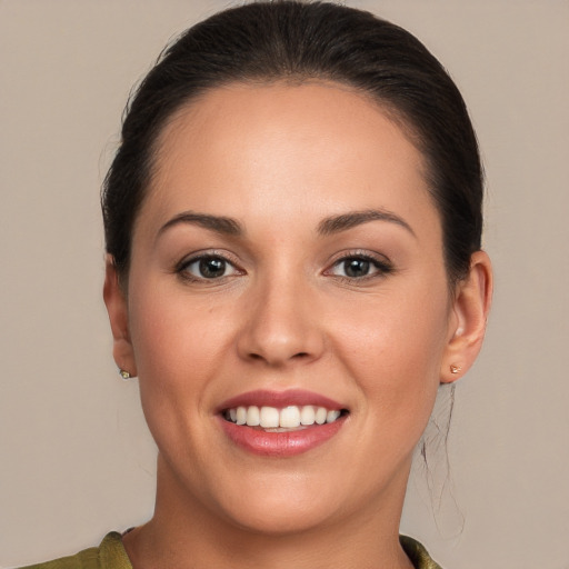 Joyful white young-adult female with long  brown hair and brown eyes