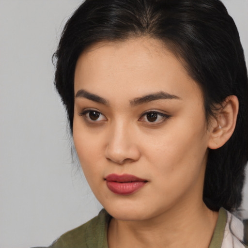 Joyful latino young-adult female with medium  black hair and brown eyes