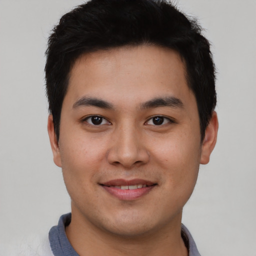 Joyful asian young-adult male with short  brown hair and brown eyes