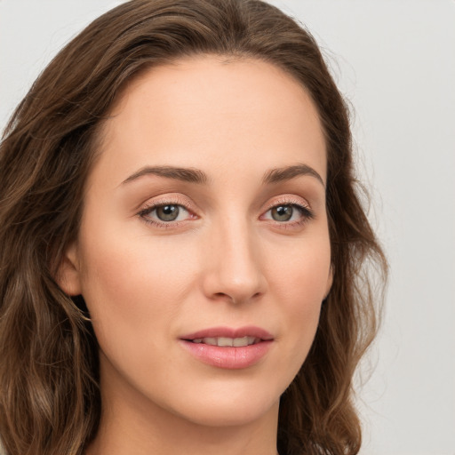 Joyful white young-adult female with long  brown hair and green eyes