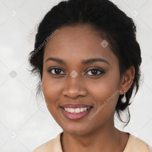 Joyful black young-adult female with long  black hair and brown eyes