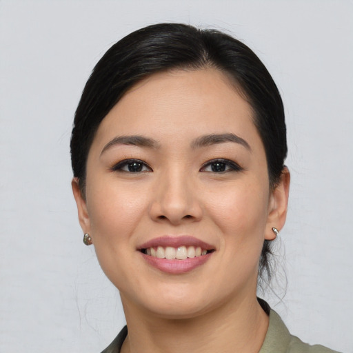 Joyful asian young-adult female with medium  black hair and brown eyes