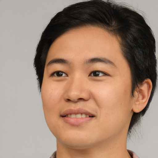 Joyful asian young-adult female with medium  brown hair and brown eyes