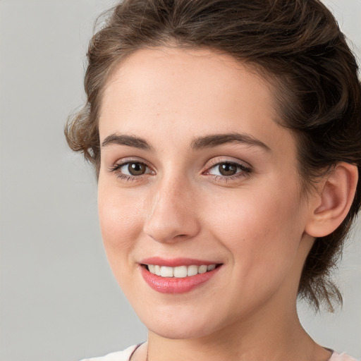 Joyful white young-adult female with medium  brown hair and green eyes