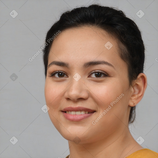 Joyful latino young-adult female with short  brown hair and brown eyes