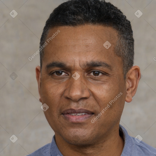 Joyful black adult male with short  black hair and brown eyes