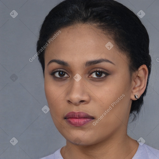 Joyful black young-adult female with short  black hair and brown eyes