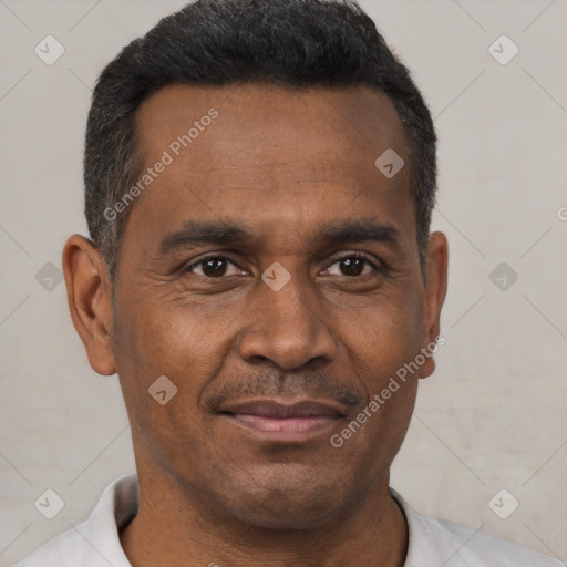 Joyful black adult male with short  black hair and brown eyes