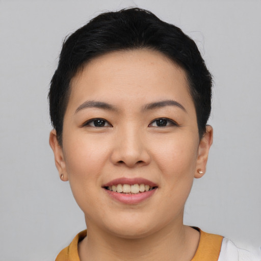 Joyful asian young-adult female with short  black hair and brown eyes