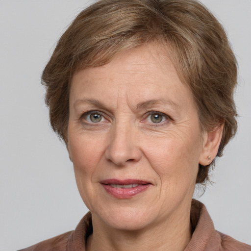 Joyful white middle-aged female with medium  brown hair and grey eyes