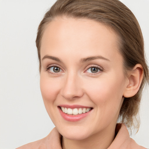 Joyful white young-adult female with medium  brown hair and blue eyes