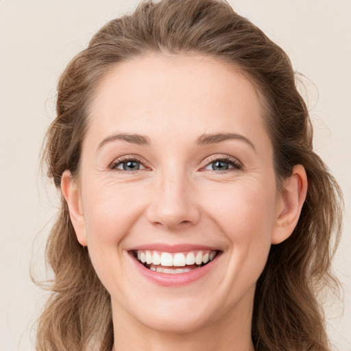 Joyful white young-adult female with long  brown hair and green eyes