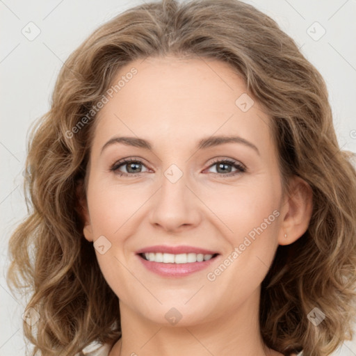 Joyful white young-adult female with long  brown hair and green eyes