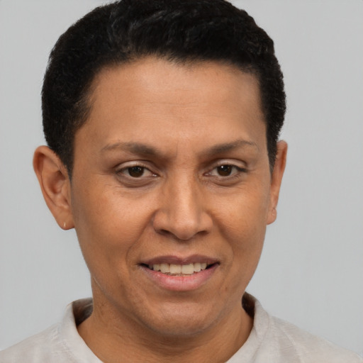 Joyful latino adult female with short  brown hair and brown eyes