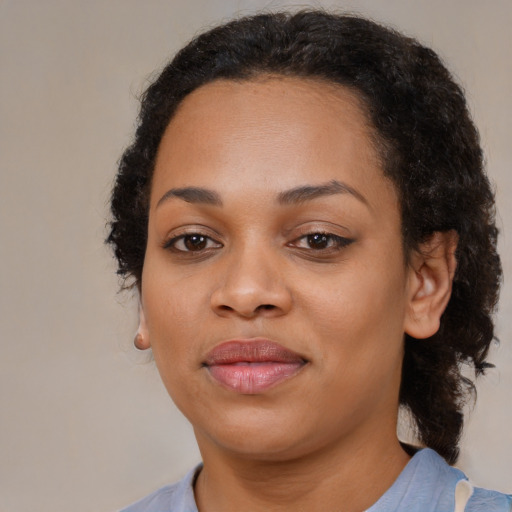 Joyful black young-adult female with medium  brown hair and brown eyes