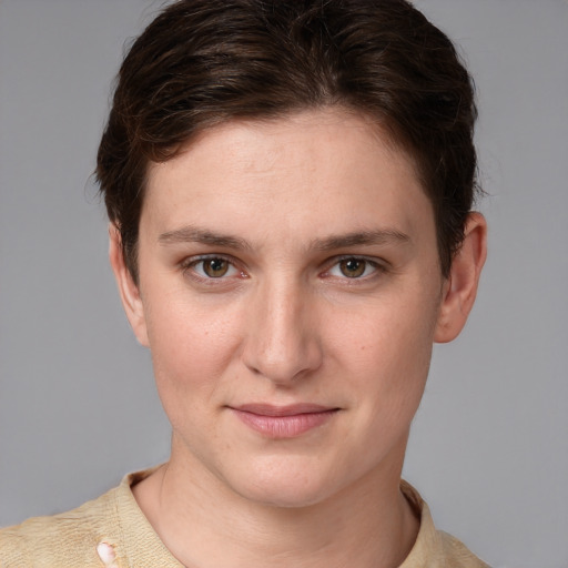 Joyful white young-adult female with short  brown hair and grey eyes