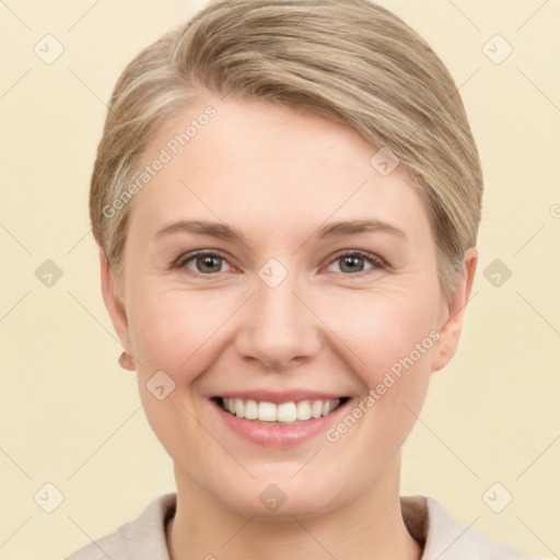 Joyful white young-adult female with short  brown hair and grey eyes